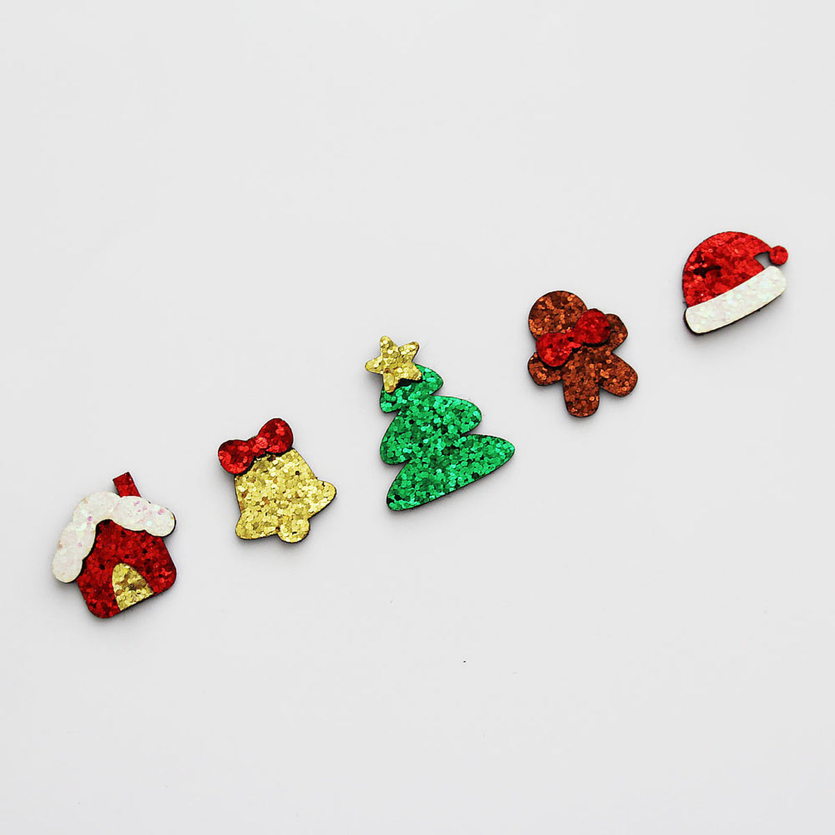 Selected Christmas glitter applique pieces arranged on white background